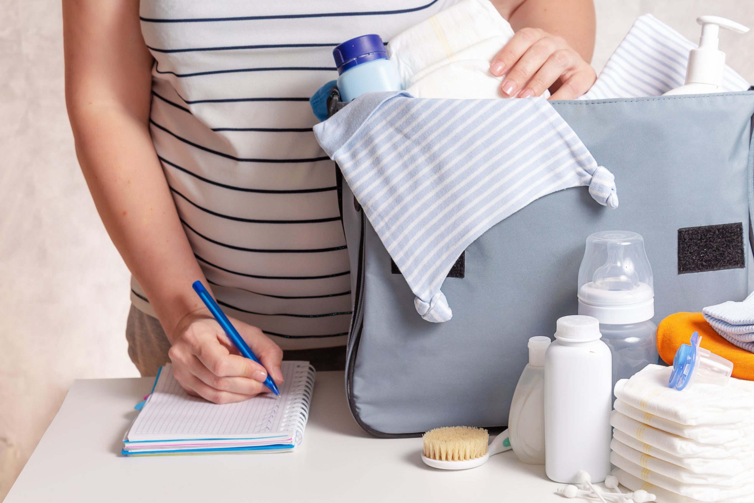 Woman packing diaper bag in maternity hospital.
